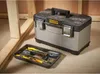 A Stanley Fatmax toolbox and its tray of tools are placed on a concrete floor next to wooden framing. Voir les images du produit