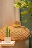 A miniature yellow tram model sits on a woven stool next to a potted cactus. Produktbild-Vorschau