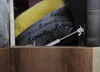 A close-up view of the interior of a storage bench, showing pillows and a hydraulic lift mechanism. Produktbild-Vorschau
