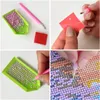 Collage of four images showing the process of diamond painting. Produktbild-Vorschau