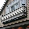 A striped balcony privacy screen attached to the exterior of a house, covering a window box. Produktbild-Vorschau