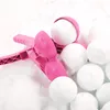 A pink snowball maker with several snowballs in the snow. Náhled obrázku produktu