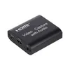 A black video capture device with HDMI input and USB ports, shown on a white background. Produktbild-Vorschau