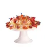 A white cake stand filled with various appetizers on toothpicks. Produktbild-Vorschau