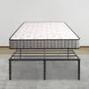 A mattress is shown placed on a black metal bed frame, which is on a light gray rug in front of a white wall. Náhled obrázku produktu