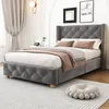 A grey upholstered bed with a tufted headboard and footboard, dressed with white and brown bedding, is shown in a well-lit room. Anteprima dell’immagine prodotto