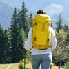 A person hiking in the mountains with a yellow backpack and trekking poles. Produktbild-Vorschau