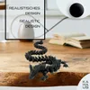 A 3D printed dragon figurine is displayed on a wooden table, with a book and a vase in the background. Text overlays provide product information. Produktbild-Vorschau