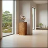 A modern interior with a wooden pedestal displaying a sculpture, next to a large window overlooking a garden. Voir les images du produit