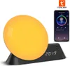 A smart wake-up light and alarm clock with a smartphone displaying its app interface. Náhľad obrázku produktu