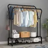 A black metal garment rack with clothes hanging on it and shoes and storage boxes on the shelves below. Náhled obrázku produktu