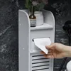 A hand is pulling toilet paper from a white bathroom storage unit. Náhled obrázku produktu