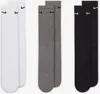 Three pairs of Nike socks in different colors (white, gray, and black) are laid out side-by-side. Produktbild-Vorschau