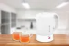 A white electric kettle and two glasses of tea are placed on a wooden table in a kitchen setting. Voir les images du produit