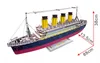 A 3D wooden model of the Titanic ship is displayed on a white background, with dimensions indicated by red arrows and text. Produktbild-Vorschau