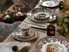 A table setting with dinnerware, cutlery, and candles, suggesting a cozy meal. Náhľad obrázku produktu