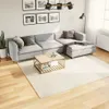 A living room scene with a sectional sofa, coffee table, and rug. Produktbild-Vorschau