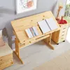A wooden children's desk with art supplies and a notebook. Produktbild-Vorschau