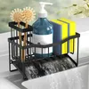 A black metal dish rack with a blue soap dispenser, two yellow sponges, and two brushes, placed over a sink with water draining. Produktbild-Vorschau