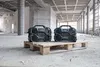 Two portable radios are placed on a wooden pallet in a construction site. Produktbild-Vorschau