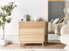 A bedroom scene with a dresser, plant, and mirror. Podgląd zdjęcia produktu