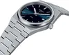 A close-up, angled shot of a Tissot PRX watch with a blue dial and silver metal band, set against a white background. Voir les images du produit