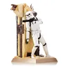 A Star Wars Stormtrooper figurine is posed leaning against a desert-themed structure, holding a blaster rifle. Anteprima dell’immagine prodotto