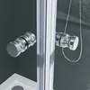 A close-up view of two chrome handles on a shower door, with a shower hose visible in the background. Produktbild-Vorschau