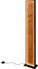 A tall, narrow floor lamp with a wood-effect panel and a black frame, standing on a white background. A black cord and plug are visible at the bottom. Náhľad obrázku produktu
