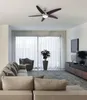 A living room with a couch, armchair, ceiling fan, and TV. Produktbild-Vorschau