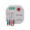 A close-up, front-facing view of a white electronic timer relay device with green and red accents. Náhled obrázku produktu
