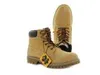 A pair of tan work boots are shown against a white background. Produktbild-Vorschau