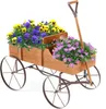 A wooden wagon filled with purple and yellow flowers, set against a white background. Voir les images du produit
