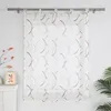 A sheer curtain with a modern abstract pattern hangs on a curtain rod against a white wall. Produktbild-Vorschau