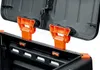 Close-up view of the inside of a black plastic compost bin with orange plastic clips holding the lid open. Náhled obrázku produktu