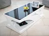 A modern white coffee table with a black glass top, displayed in a living room setting. Podgląd zdjęcia produktu