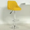 A yellow bar stool is shown in a studio setting against a white wall and light gray floor. Voir les images du produit
