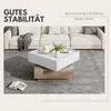 A modern living room scene featuring a white sectional sofa and a square coffee table with a rotating top. Produktbild-Vorschau