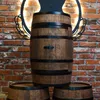 A wooden barrel used as a table, with a brick wall in the background. Náhled obrázku produktu