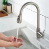 A person is washing their hands under a kitchen faucet. Produktbild-Vorschau