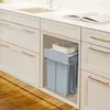 A built-in kitchen trash can system with two bins and a small basket on top, installed under a kitchen counter. Náhľad obrázku produktu