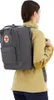 A person wearing a sweater and backpack. Produktbild-Vorschau