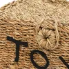 A close-up view of a woven basket with the letters 'TOYS' embroidered on it in black thread. Produktbild-Vorschau