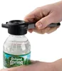 Hands using a multi-bottle opener to open a Poland Spring water bottle. Produktbild-Vorschau