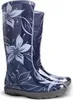 A pair of blue rain boots with a floral pattern. Produktbild-Vorschau