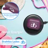 A flat lay of a purple AirPods Pro case on a wireless charger, surrounded by beach accessories like flip-flops and a bikini. Produktbild-Vorschau