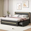 A modern bedroom with a gray upholstered bed featuring LED lighting and storage drawers.