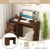 A desk with a computer, lamp, and chair in a room setting, with a smaller inset image of the desk and diagrams below. Produktbild-Vorschau