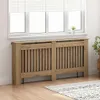 A radiator cover in front of a window with blinds. Voir les images du produit