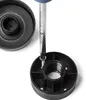 A screwdriver is being used to attach a black plastic screw base to a larger black plastic component. Produktbild-Vorschau
